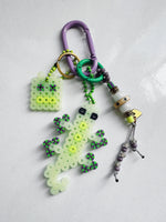 Load image into Gallery viewer, RoboLizard Bag Charm - glow / acid purple
