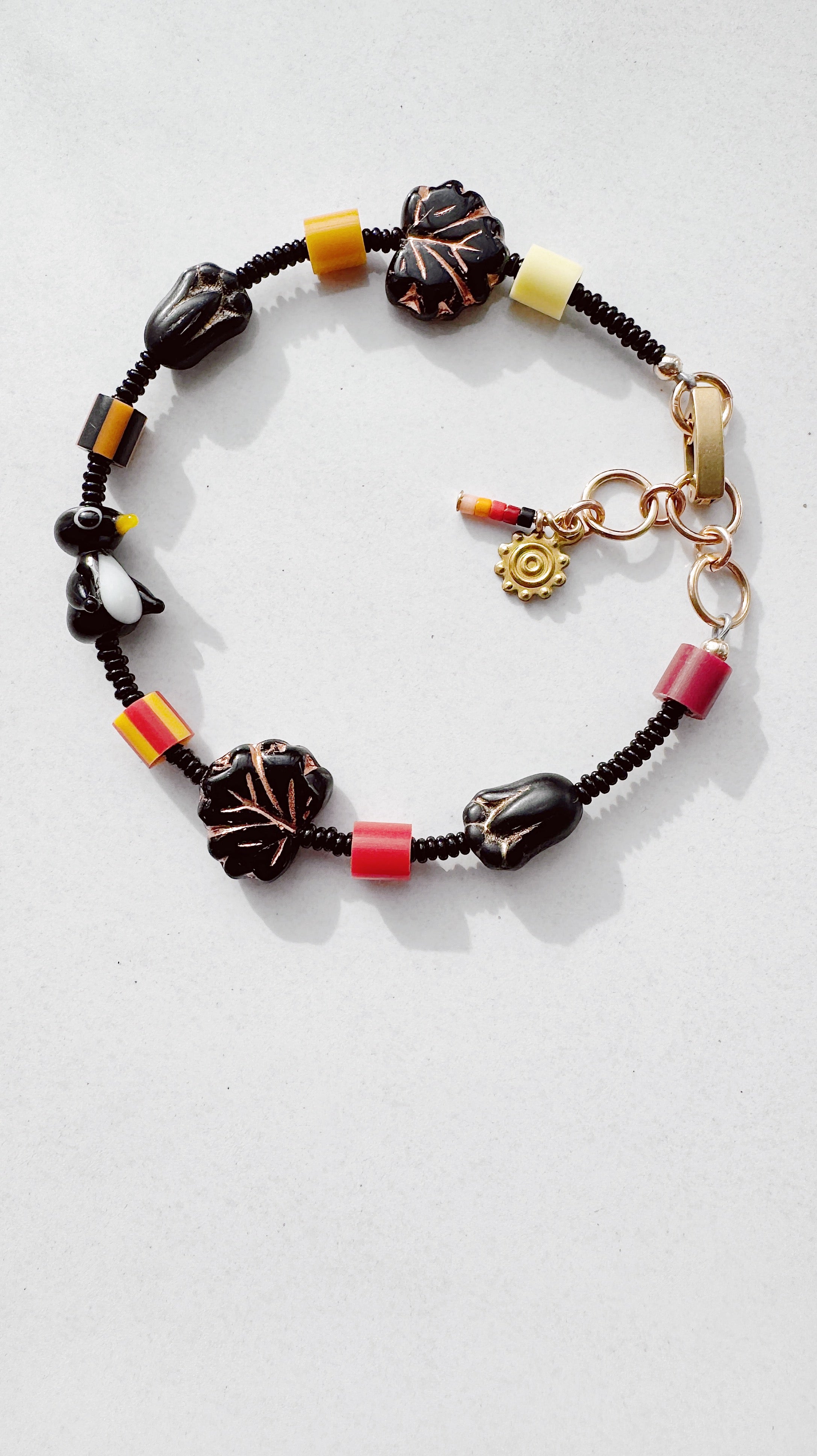 Critter Bracelet - black penguin - brick / lemon
