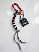 Load image into Gallery viewer, Keychain with beads and a small robot figure on a white background
