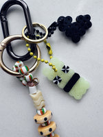 Load image into Gallery viewer, XXXL Long Bag Charm - green swirl skull + surprise!
